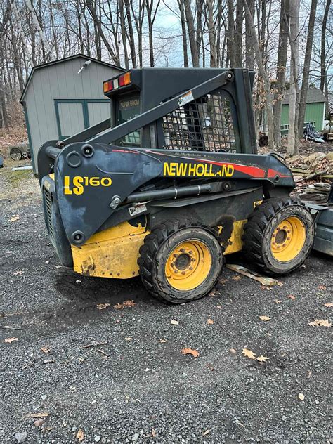 lifting boom to get to the battery on skid steer|nh ls160 skid steer battery removal.